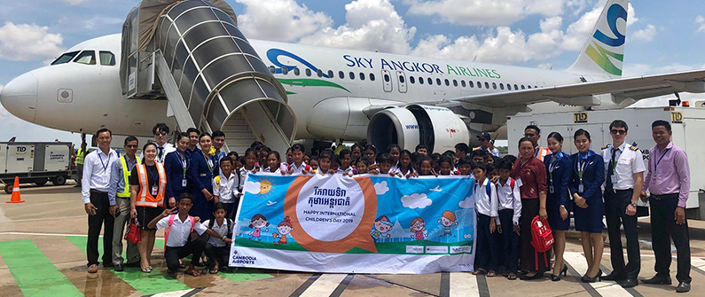 Several local airlines offered to take the children on tours of their planes. Here, a class gathers at the Siem Reap International Airport to pose with the crew of Sky Angkor Airlines