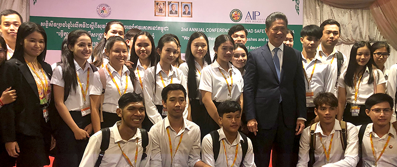 The Minister of Public Works and Transport Sun Chanthol poses with students at the AIP road safety conference. 