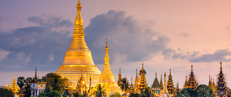 The Shwedagon Pagoda’s golden spires glow with the setting sun.